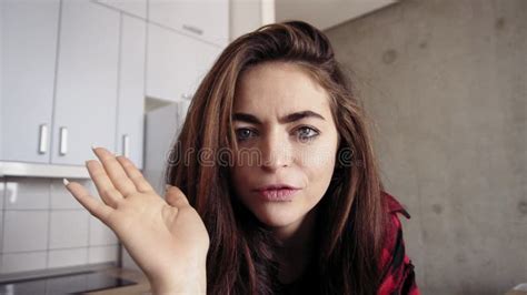 Stunnungly Beautiful Brunette Girl Recording Herself On Video And Talking About Something Stock