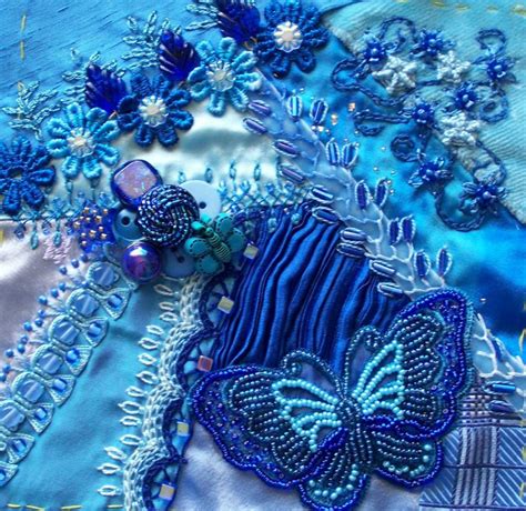 A Blue Piece Of Cloth With Flowers And Butterflies On It