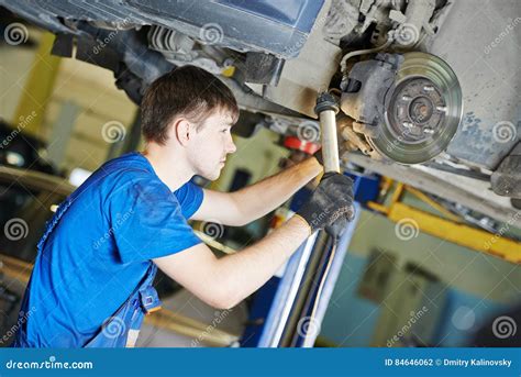 Auto Mechanic At Car Suspension Repairing Stock Photo Image Of