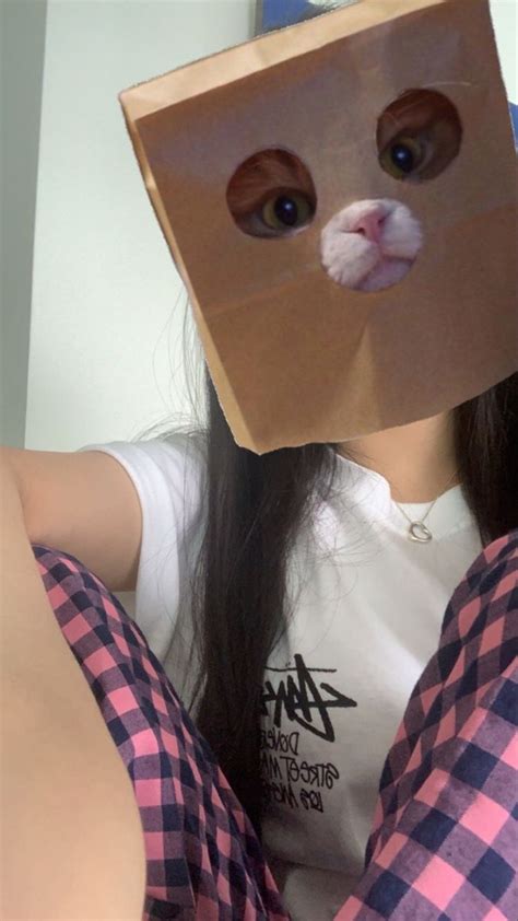 A Woman Wearing A Paper Bag Over Her Head With A Cat S Face On It