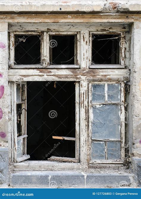 Old Wood Windows with Broken Glass. Peeled Away Paint. Part of the