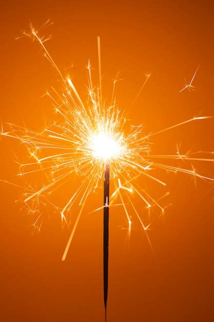 Premium Photo | Party sparkler little fireworks on orange