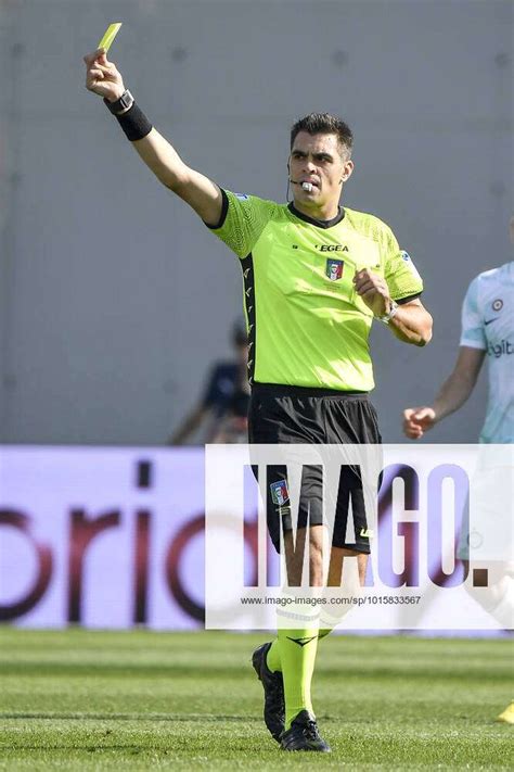 Referee Simone Sozza Shows A Yellow Card During The Serie A Football