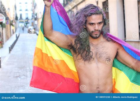 Determined Gay Man Marching With The Rainbow Flag Stock Photo Image