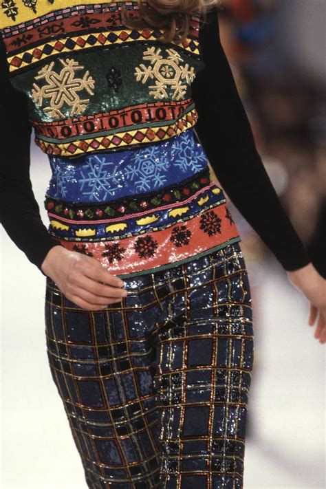 A Model Walks Down The Catwalk In A Multicolored Sweater And Patterned