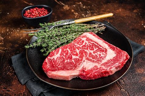 Premium Photo Black Angus Rib Eye Steak Raw Marbled Beef Meat With