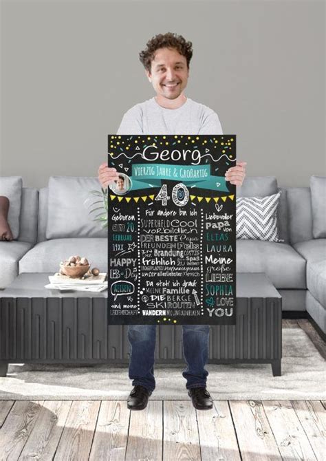 A Man Holding Up A Chalkboard Sign In His Living Room