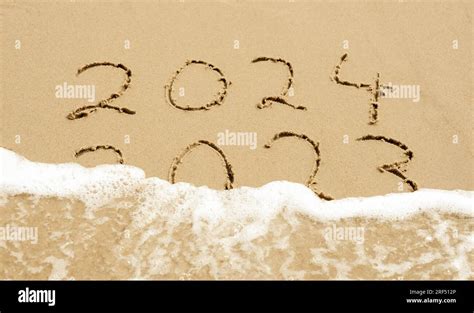 Symbol For The New Year 2024 Wave Is Washing Away The Inscription 2023