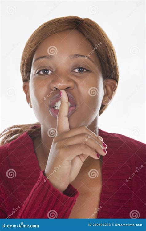 African Woman With Finger On The Lips Signing Keep Quiet Stock Photo