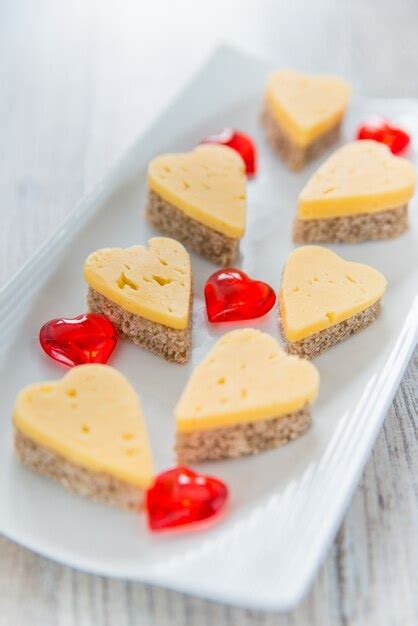 Premium Photo Heart Shaped Cheese Sandwiches On A White Plate