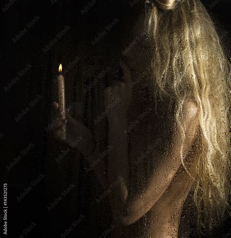 Curly Nude Blonde Woman With Candle On Dark Background Stock Photo Adobe Stock