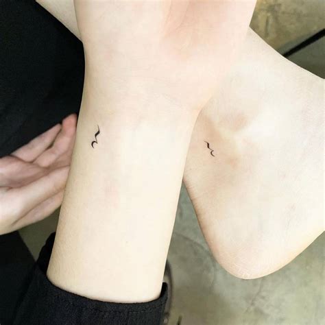 Minimalistic matching quarter rest symbol tattoo for