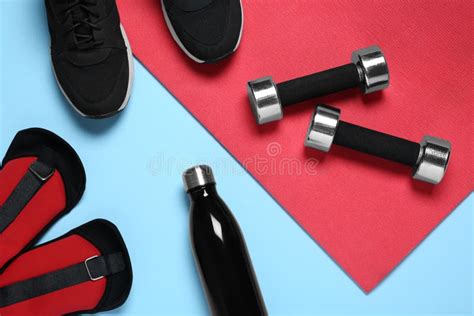 Exercise Mat Dumbbells Bottle Of Water Weights And Shoes On Light