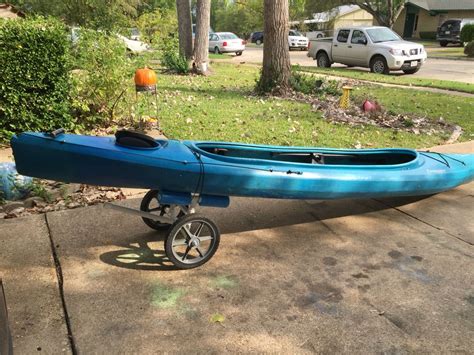 a blue kayak sitting on top of a sidewalk