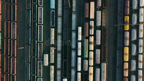 Aerial Top View Of Freight Trains And Cars Standing At The Distribution