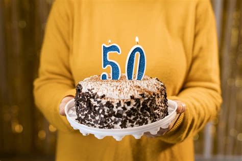 Woman Holding A Festive Cake With Number 50 Candles While Celebrating Birthday Party Birthday