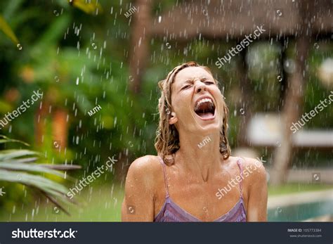 Attractive Woman Under Tropical Rain In An Exotic Garden Screaming