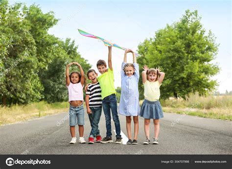 Little children flying kite outdoors Stock Photo by ©serezniy 304707998