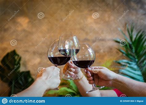 Party And Celebration Concept Friends Clinking Glasses Of Red Wine