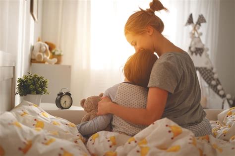 Premium Photo Morning Awakening Mother Wakes Her Daughter In Bed In