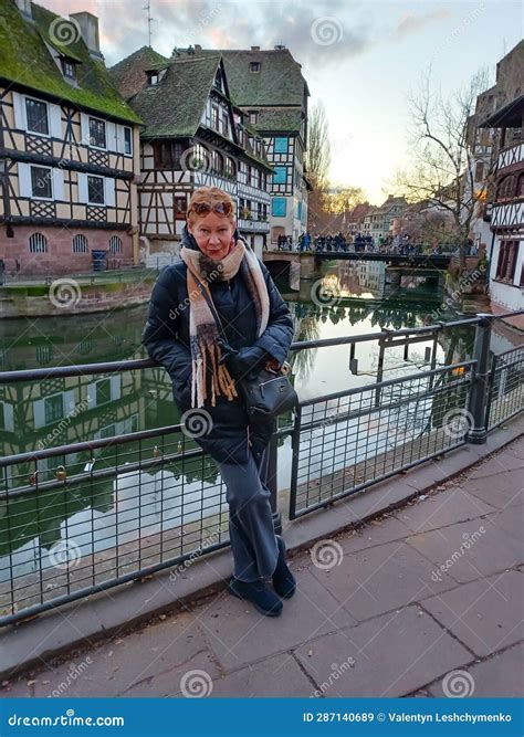 Close Up Portrait Mature Woman At The Amazing Traditional Colorful Houses In La Petite France
