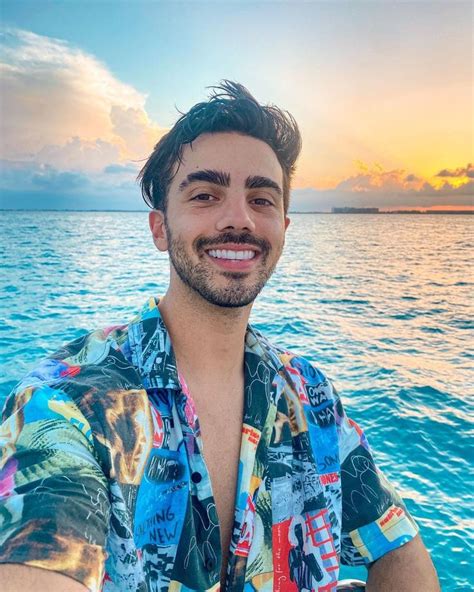 A Man Taking A Selfie While On A Boat In The Ocean At Sunset Or Sunrise