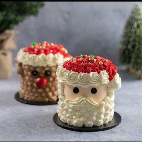 Two Cakes Decorated To Look Like Santa Claus