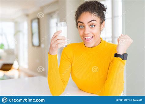 Young African American Woman Drinking A Glass Of Fresh Milk Screaming