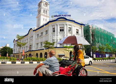 A tourist in a trishaw views the Wisma Kastam (Malayan Railway Building), part of Penang's ...