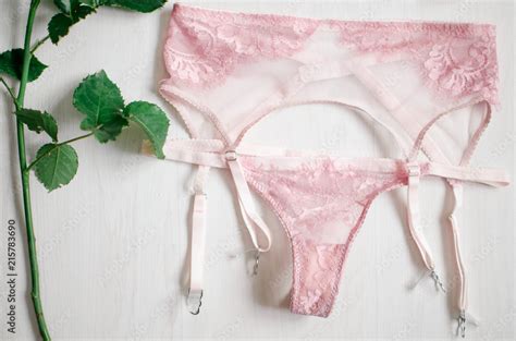 Sexy Pink Lingerie Set With Stocking Suspender Lace Underwear On The White Background With Rose