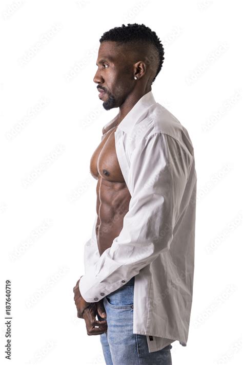African American Bodybuilder Man Wearing Jeans And Open Shirt On Naked Muscular Torso Isolated