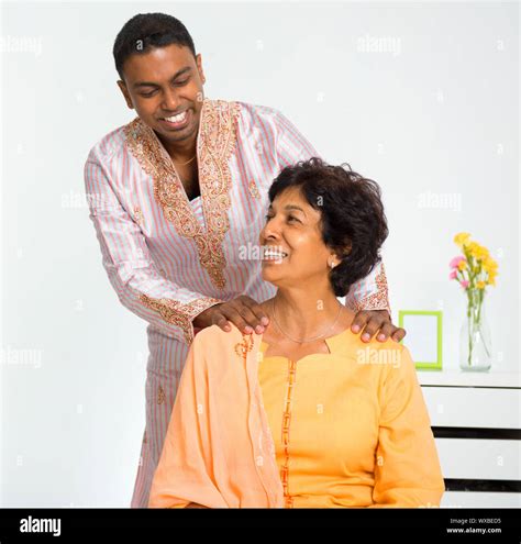 A Lovely Mature Indian Woman Enjoying A Shoulder Massage From Her Son At Home Stock Photo Alamy