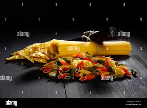 Variety Of Types And Shapes Of Italian Pasta On Black Table Stock Photo