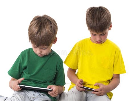 Meninos Que Jogam Jogos Nos Tablet Pc Foto De Stock Imagem De