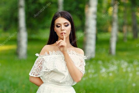 Portrait Of Beautiful Sensual Brunette Girl In White Dress Put Stock