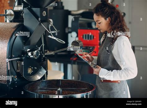 Coffee Roaster Machine And Barista Woman With Tablet Write Pen At