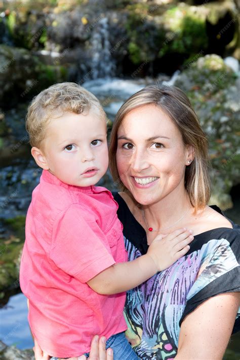 Premium Photo Portrait Of A Happy Mother And Son Smiling Outdoors