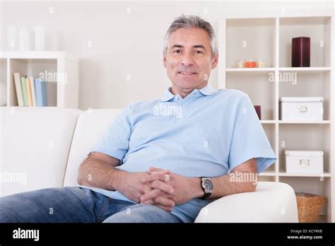 Portrait Of Happy Mature Man Sitting On Sofa Stock Photo Alamy
