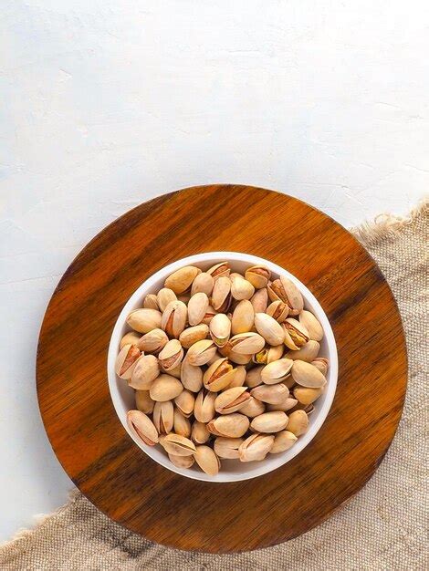 Premium Photo Cup With Selected Inshell Pistachios On Light