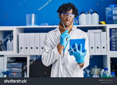 African American Man Scientist Using Touchpad Stock Photo