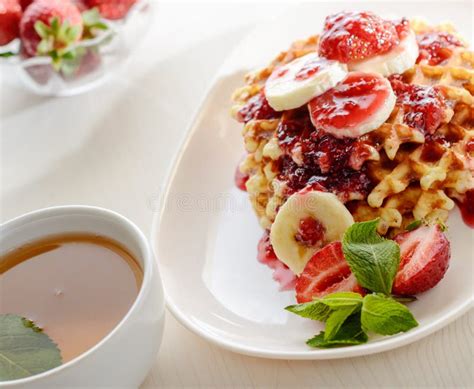 Belgium Waffles With Strawberries Mint And Raspberry Jam Stock Image