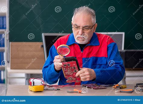 Old Repairman Repairing Computers In The Classroom Stock Image Image