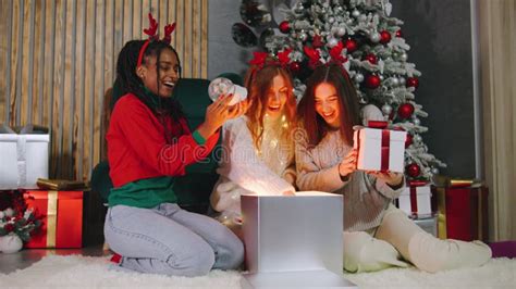 A Group Of Joyful Girls Celebrate Christmas With A Glass Of Champagne