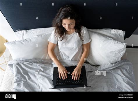Beautiful Brunette Girl In Bed With A Laptop Work From Morning To Late Night Electronic