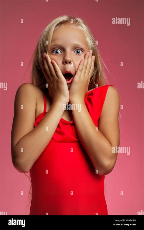 Portrait of surprised excited screaming little blonde baby girl on a ...