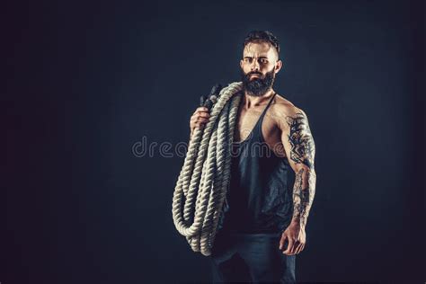 Muscular Man Working Out With Heavy Rope Photo Of Man With Naked Torso