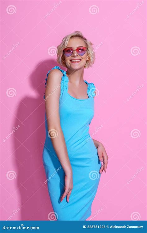 Portrait Of Beautiful Blonde Woman In Blue Dress With Sunglasses Posing