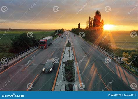 Highway with car at sunset stock image. Image of blurred - 44519329