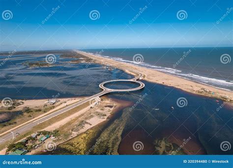 Laguna Garzon Bridge Spanning The Ocean Near A Sandy Shore Stock Photo