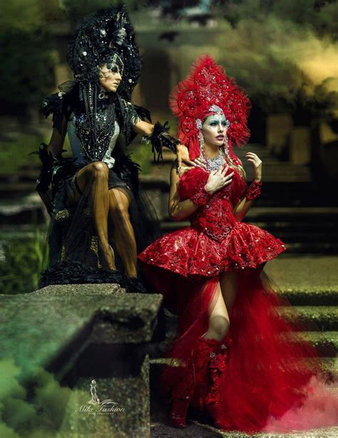 two people dressed in costumes sitting on steps